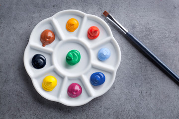  Palette with paints and brush isolated