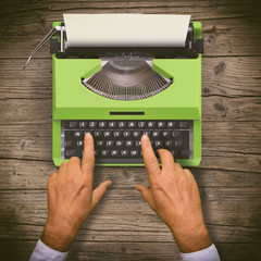 Hands writing on old typewriter