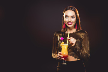 brunette glamorous smiling girl with alcohol cocktail on black