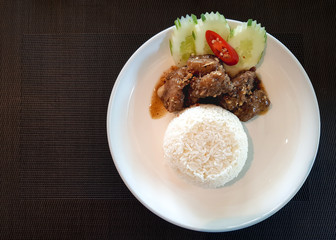 Chopped pork ribs fried with garlic gravy served with rice