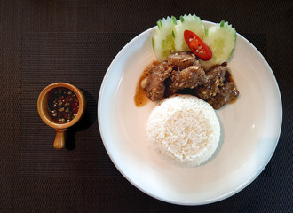 Chopped pork ribs fried with garlic gravy served with rice