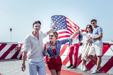 Make face. Pleased brunette boy keeping smile on his face while looking forward