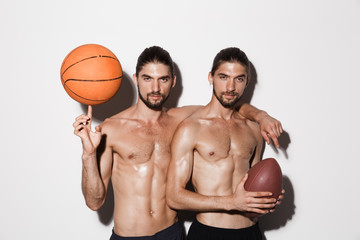 Portrait of a two confident muscular shirtless twin brothers - Powered by Adobe