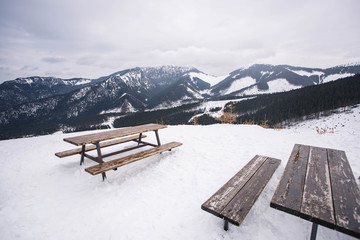 Jasna ski resort. Amazing view from the wooden table and benches to  mountains tops in the foggy...