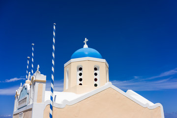 A church in Oia, Santorini, Greece set against a deep blue sky