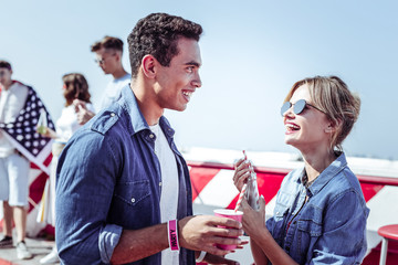 Great atmosphere. Positive delighted female laughing at joke while staring at her colleague