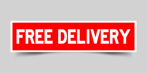 Red color sticker in word free delivery on gray background