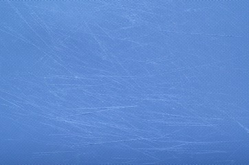 The photo of scratch blue color plastic chopping board taking as background.