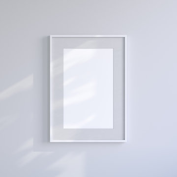 White blank frame on the light gray wall. Frame mock up.