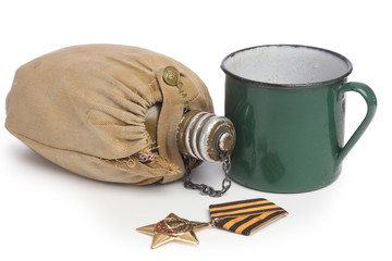 Green mug and khaki fask in textile cover  and medal of honour isolated on white background