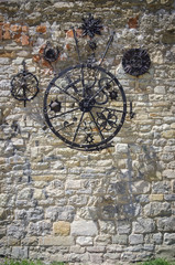 Fototapeta na wymiar old iron wheel on the wall