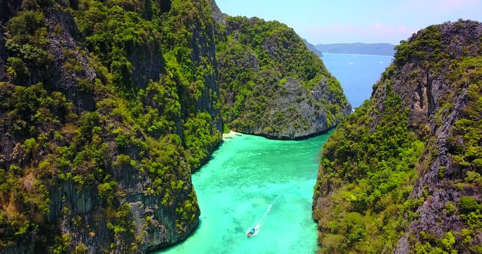 Single Boat in Narrow Tropical Bay Surrounded by Limestone Karst Islands with Turquoise Blue Water - Pileh Bay (Ko Phi Phi Le), Thailand