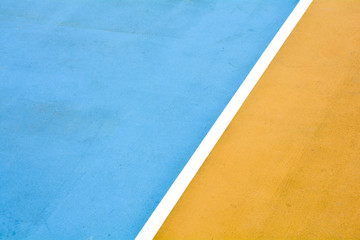 white line with yellow and blue basketball court
