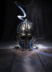Warrior Spirit. Beautiful, historic helmet of an ancient warrior on a wooden table