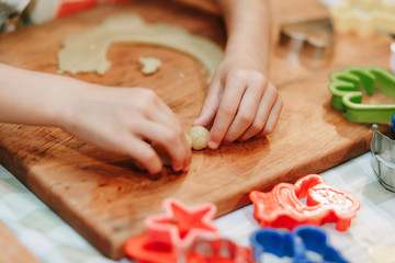 Child mixing flour in the kitchen, making dough