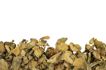 Dried slices of Cassumunar ginger arrange on lower horizontal with empty space above on white background. Raw material ingredient for cuisine and herbal therapy.