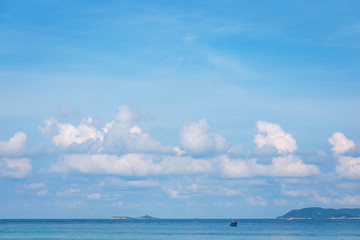 Plakat sea with blue sky and white clouds.