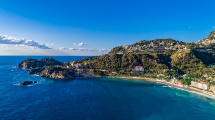 Fototapeta na wymiar Aerial. View from beach toTaormina. Taormina has been a tourist destination since the 19th century. Located on east coast of the island of Sicily, Italy.