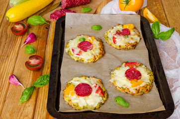 zucchini pizza with pepperoni, tomatoes, cheese and basil
