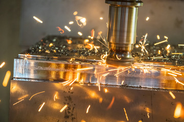 The CNC milling machine cutting the mold part in roughing  process with the burning  ship.Tool wear between cutting . © Pixel_B