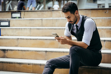 portrait of smart business man use smartphone technology outdoor