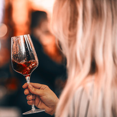 Beauty with red and wose wine glass - front view hand