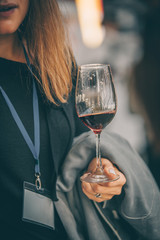 Beauty with red wine glass - front view hand