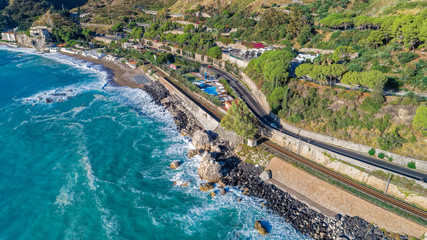 Fototapeta na wymiar Aerial. Beach view near Taormina. Taormina has been a tourist destination since the 19th century. Located on east coast of the island of Sicily, Italy.