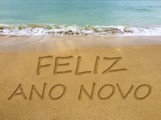 Happy new year written in the sand on a beautiful Brazilian beach (translation portuguese: happy new year).