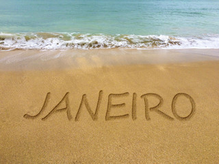 January written in the sand on a beautiful Brazilian beach (translation portuguese: january).