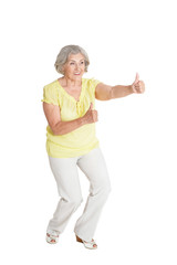 Portrait of senior woman with thumbs up
