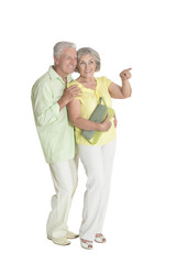 Portrait of senior couple pointing something on white background