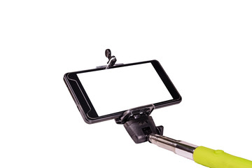 Selfie stick with modern smartphone isolated on a white background