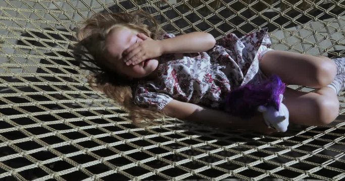Girl child in a hammock net