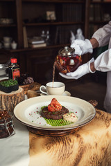 High kitchen: grilled beef meat on msshed green peanut with burdock root puree. Servant pours tea.