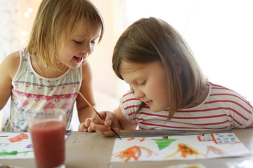 Fototapeta premium Children's creativity. Sisters draws watercolors