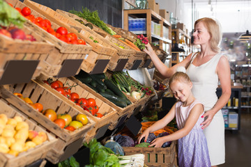 Portrait of young woman and girl gladly shopping