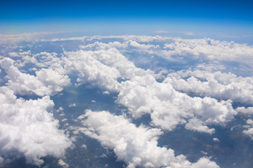 view of the clouds below from the plane