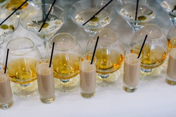 A row of martini and brandy glasses on bar. Celebration or other event.	