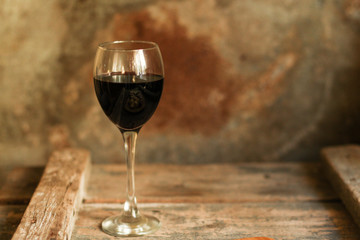 glass of red wine on a wooden table. top view. food background