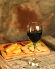 glass of red wine on a wooden table. top view. food background