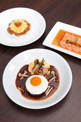 Japanese spicy Tan Tan pork over rice, salmon tataki salad and hamburger steak with sunny side up egg