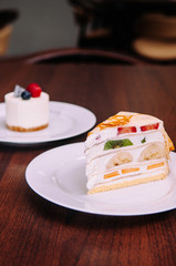 Creamy Crepe cake with mix fruits on white dish in bekery cafe