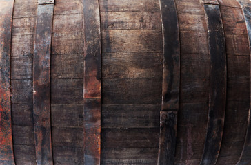 Old brown oak barrel with rivets closeup