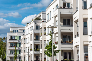 The facade of some white modern apartment buidlings seen in Berlin, Germany