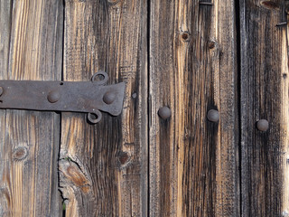 Old vintage wooden door with hand-made detail of wrought iron
