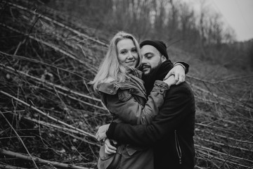 Black and white portrait of couple walking in the wilderness. Young people in love. Travel and tourism.