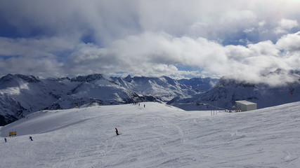 Fototapeta na wymiar Image of ski resort in the winter with snow covered mountains and slops