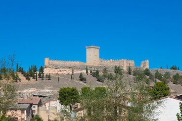 Fototapeta na wymiar old wall and turret of castle in Penaranda de Duero village, landmark and public monument from eleventh century, in Burgos, Castile and Leon, Spain, Europe
