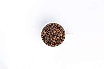 Obraz na płótnie Canvas Coffee grains in a white coffee cup on a white background.